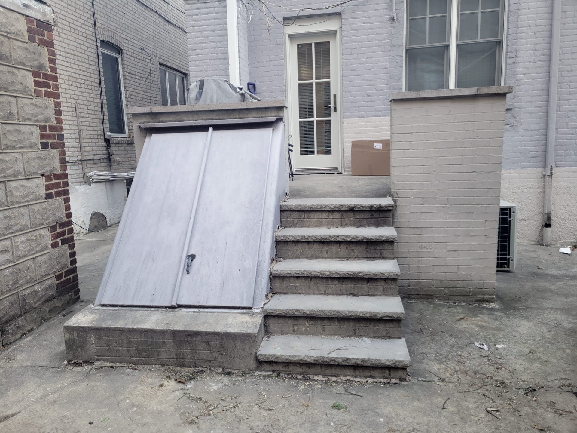 Wood-Clad Backyard Retreat — before: Cellar door and concrete steps, before